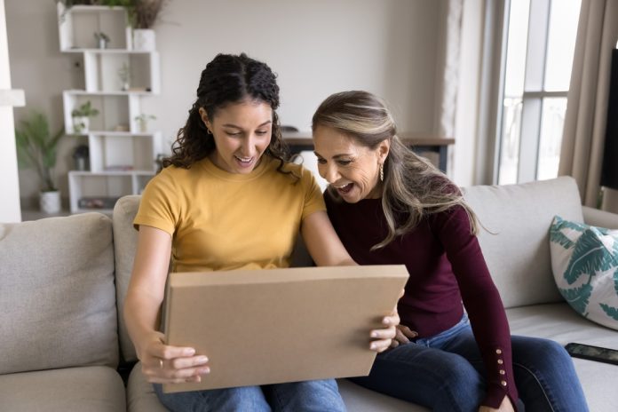 Two women opening a box