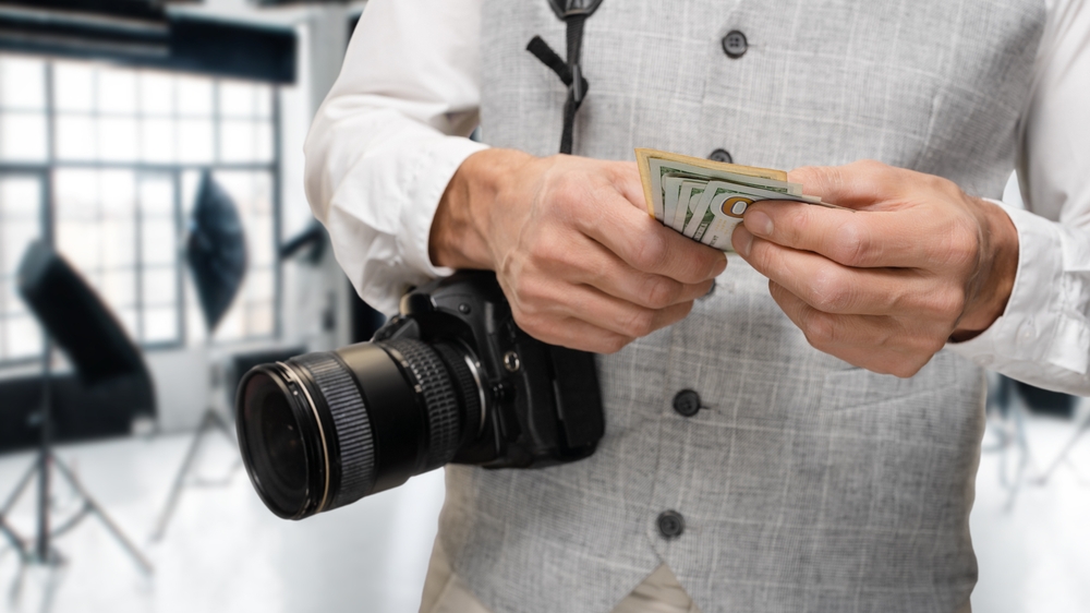 photographer holding cash