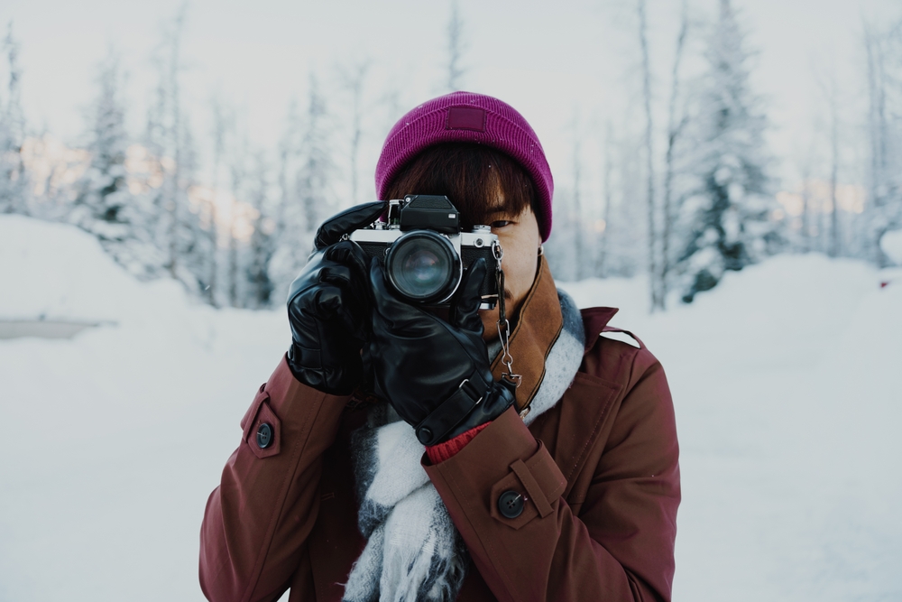 photographer with vintage camera in winter