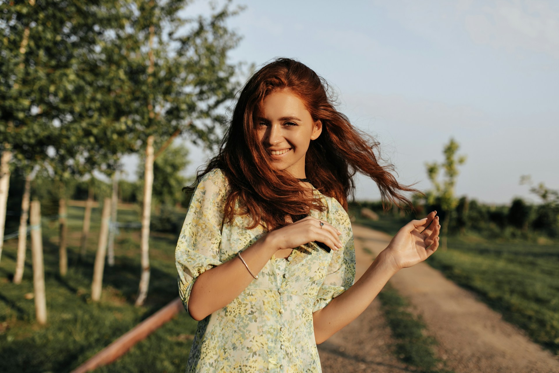 woman standing on dirt road