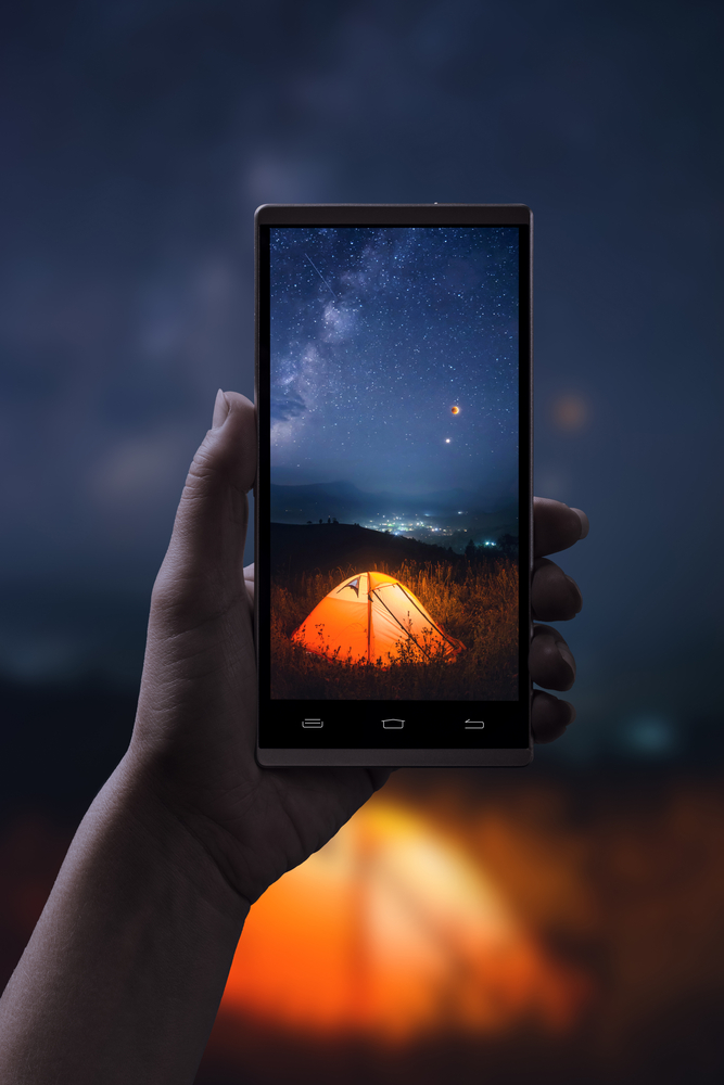 using a smart phone for astrophotography stars over a glowing tent