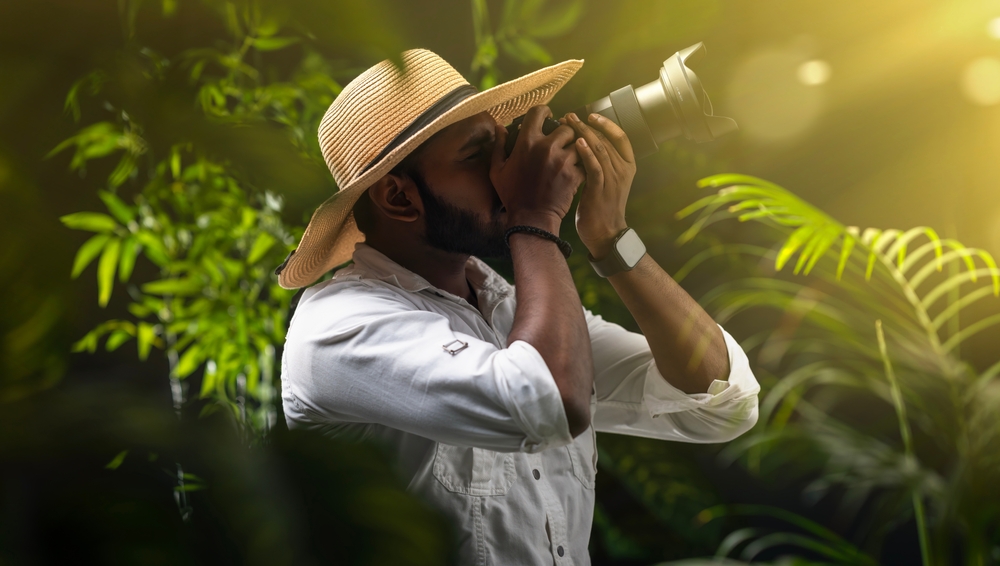 nature photographer with camera and lens