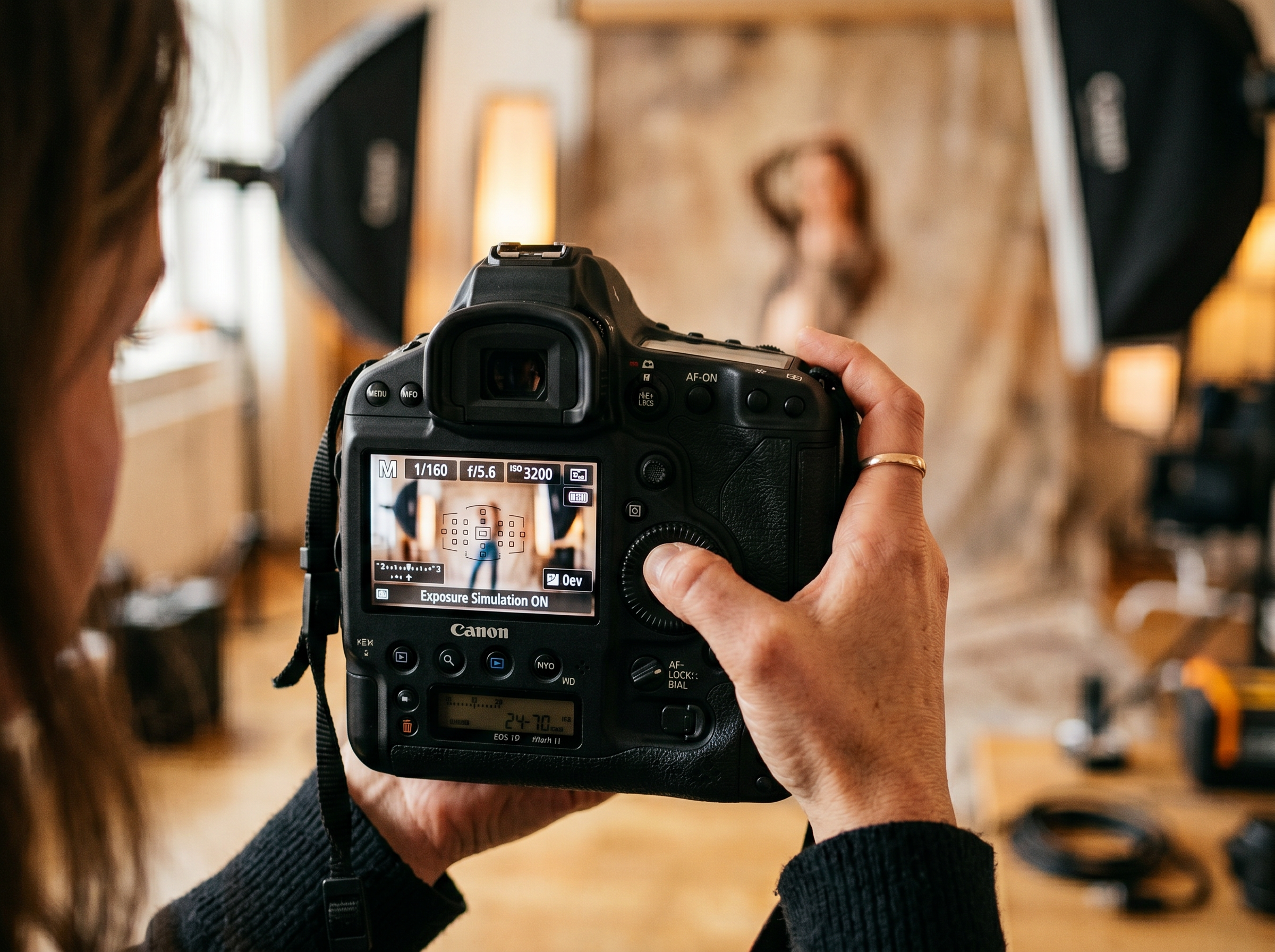 Close-up of professional DSLR camera LCD showing exposure metering display during a boudoir photography session