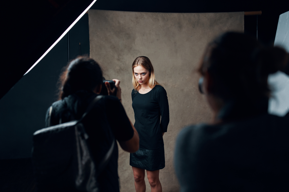 Photographer using single-point autofocus on a model during a dim studio portrait session